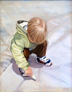 A young child with blonde hair wearing a green jacket, black pants, and sneakers, squatting on a concrete surface, playing with a toy truck.