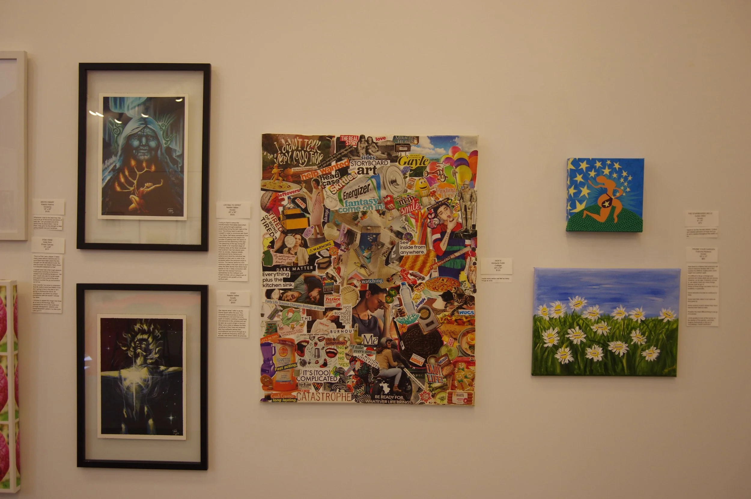 Gallery wall with five artworks: two portraits in black frames, a collage in the center, a small stylized painting of a running woman with stars, and a painting of daisies under a blue sky.
