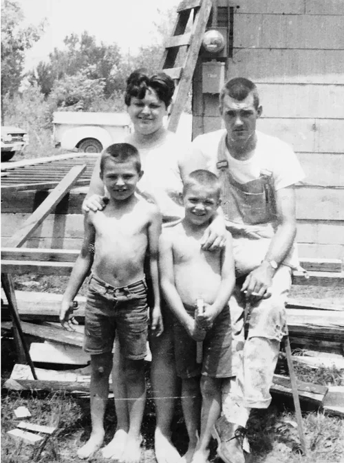 The Glover Family with the Dirty Little Glover Boys from the book Barefoot and Bulletproof, standing in Picher, Oklahoma the most toxic town in America