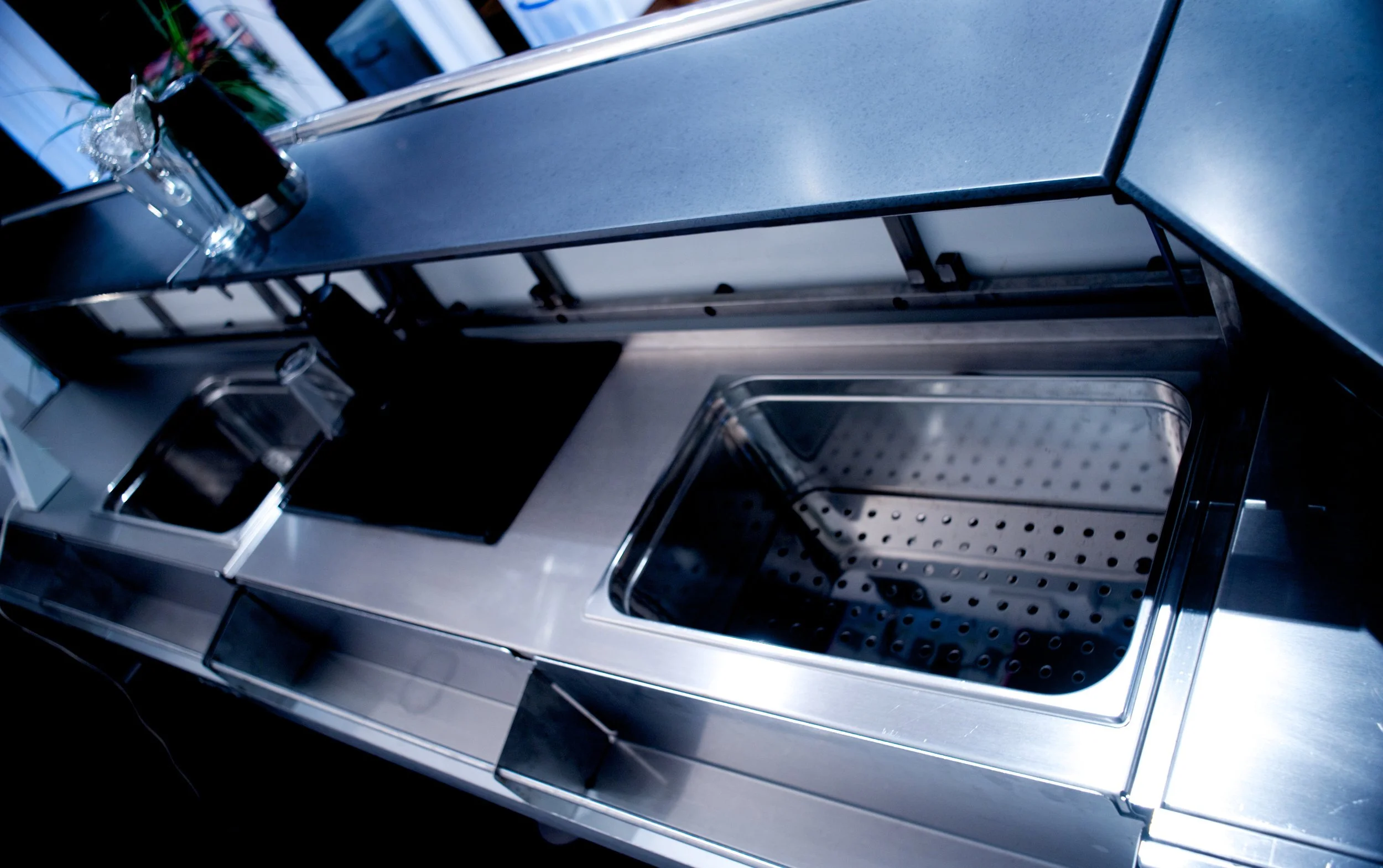 Bartender side with sink for ice, speed rail and storage