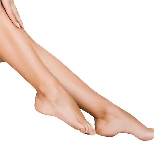 Close-up of a person's smooth, well-groomed legs and feet isolated against a white background