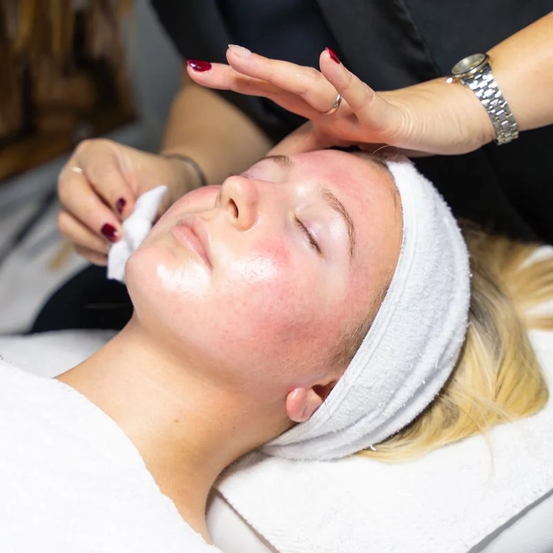 Woman receiving facial treatment at a spa