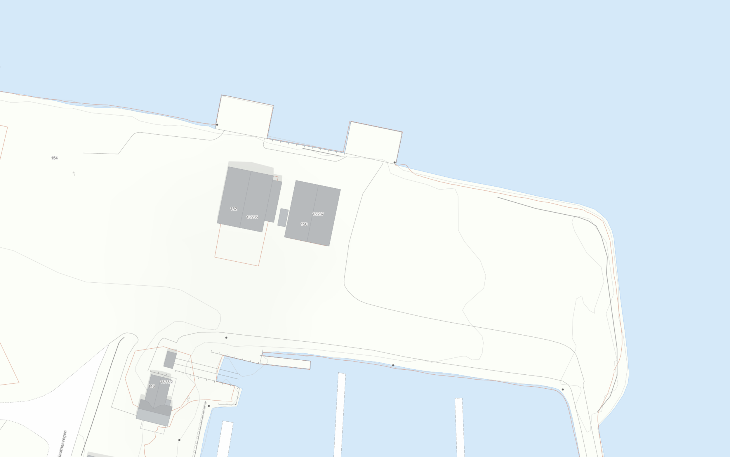 Kart som viser et område ved vann, med bygninger, veier og skjermede områder.