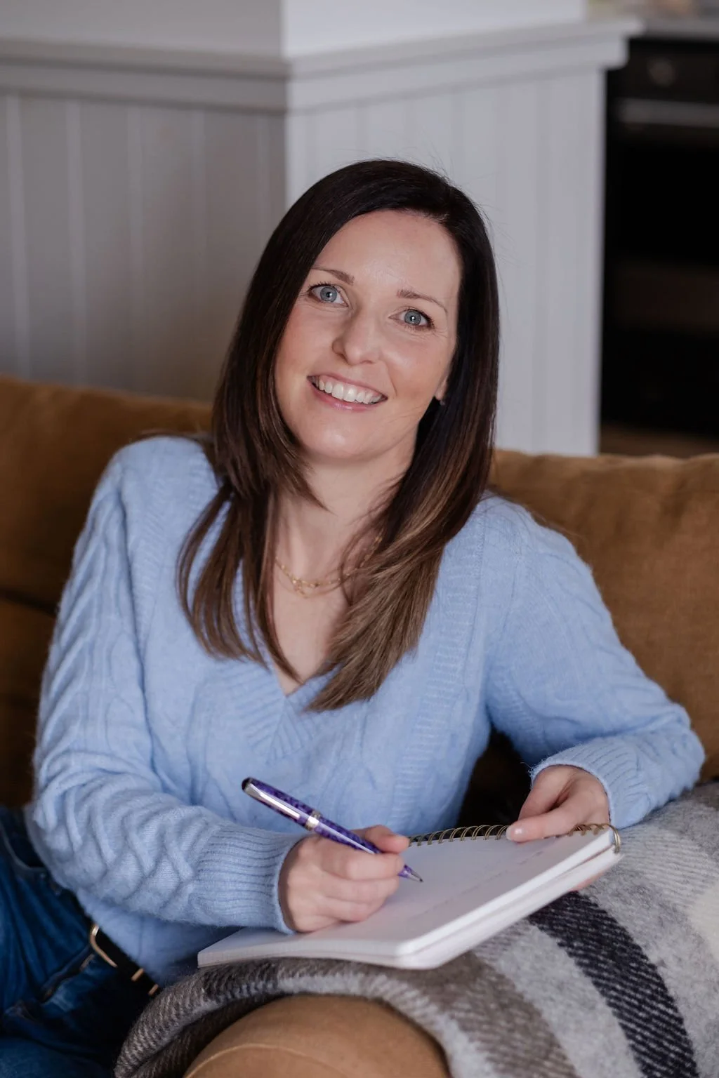 Genna Nelson, nutrition and genetics practitioner taking notes, natural light portrait