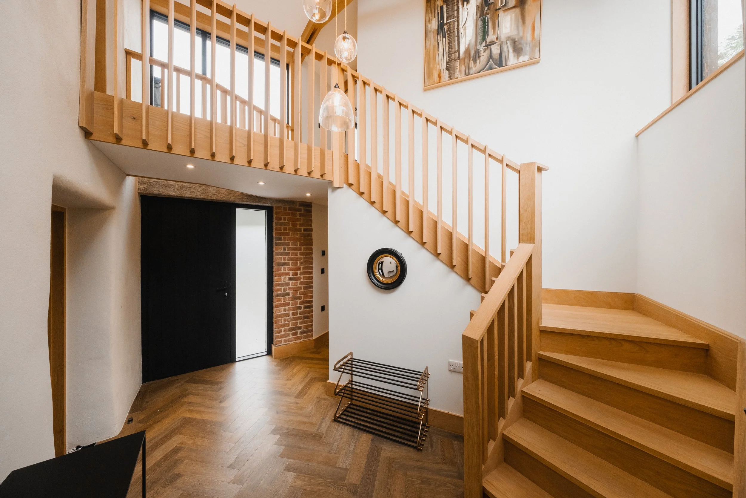 Light spills gently across the entrance way, where warm timber and open space create a calm, welcoming first impression. It is a quiet moment of arrival before the house slowly unfolds around you.