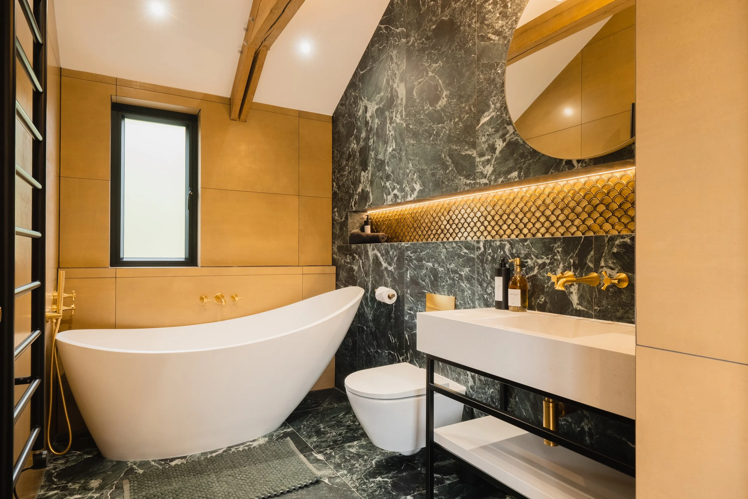 Designed for slow starts and long soaks, the family bathroom feels calm, indulgent and beautifully considered. Warm textures and soft lighting create a space that invites you to unwind completely.
