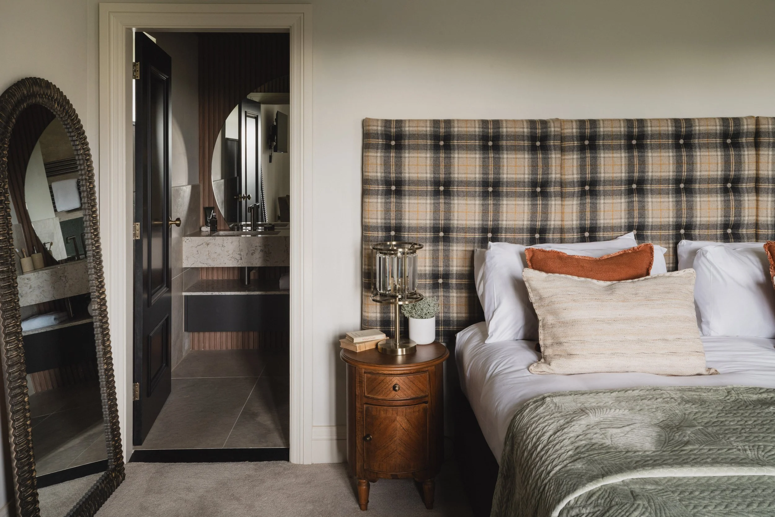 thoughtful details continue through to the ensuite, where warm wood tones and soft lighting create a space that feels both considered and effortlessly comfortable.