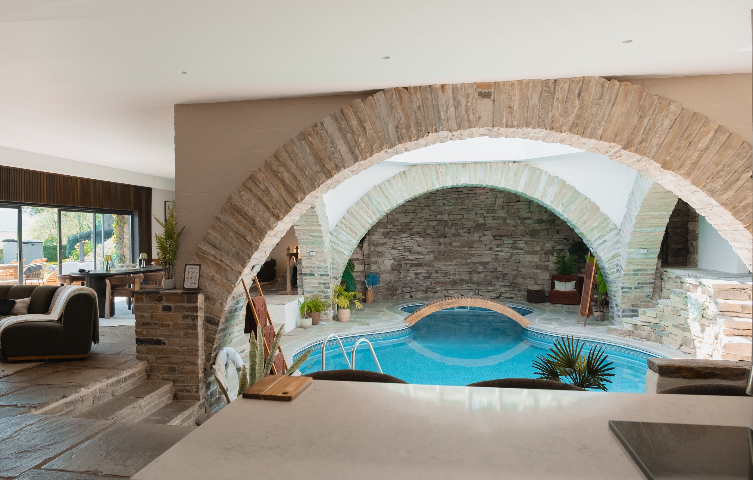 Discover Underhill’s extraordinary open-plan design, where the private indoor pool sits beneath sweeping stone arches and flows effortlessly into the surrounding living spaces.