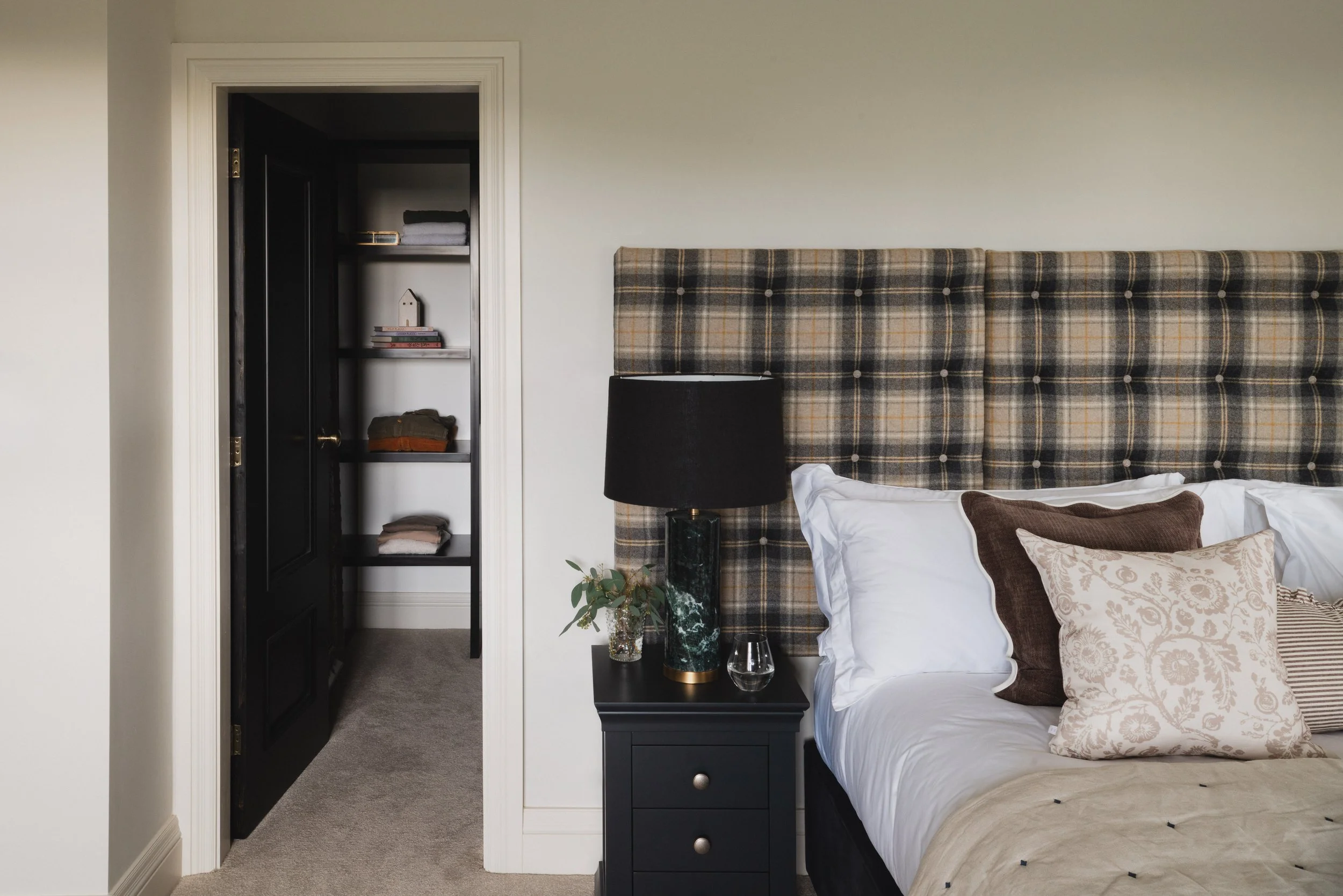 this corner draws you in with its rich velvet sofa and soft, ambient light, offering a comfortable place to unwind with a drink or simply settle into the stillness of the space.