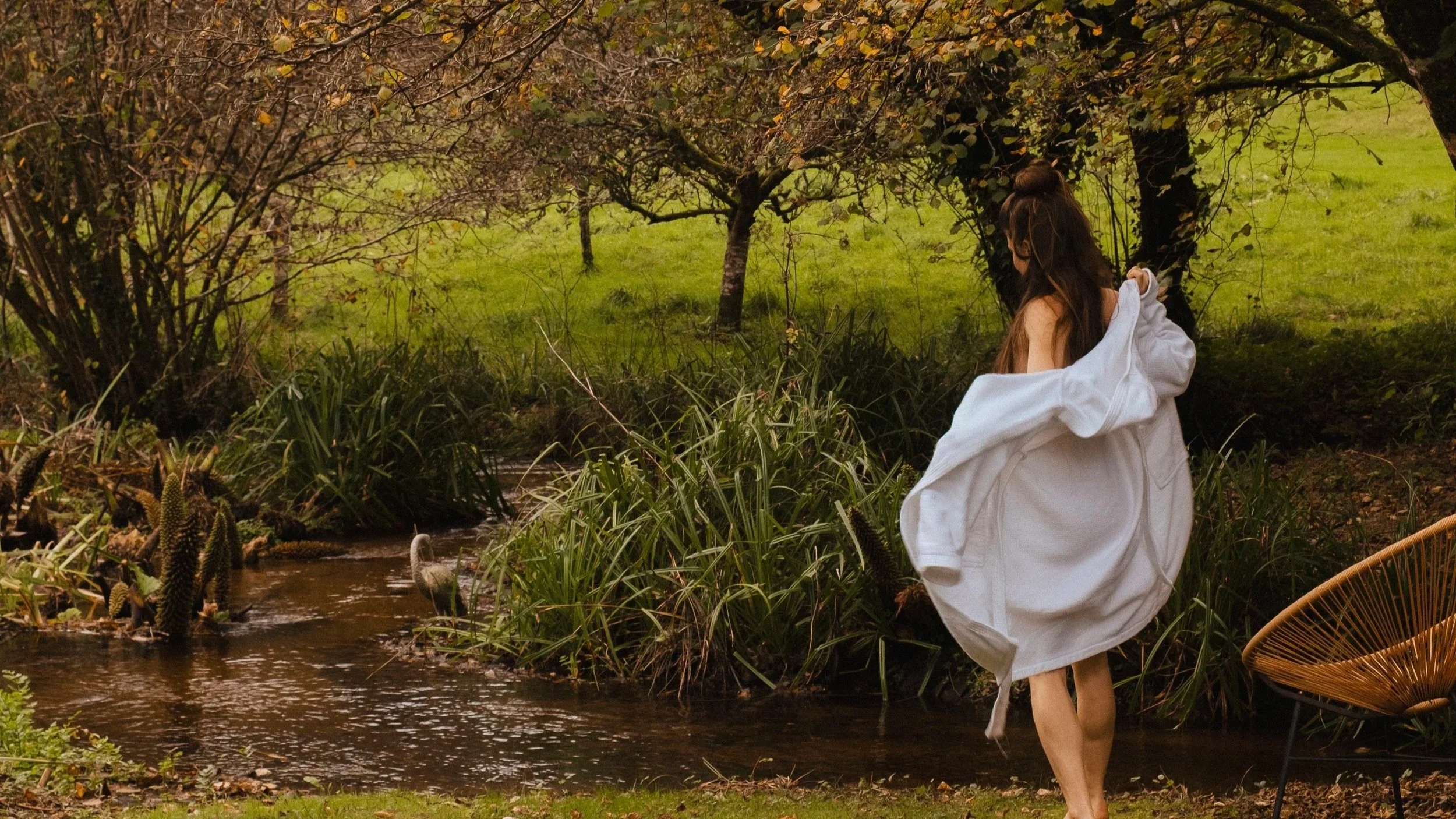 A gentle stream winds through the grounds, inviting barefoot wanderings and reflection.