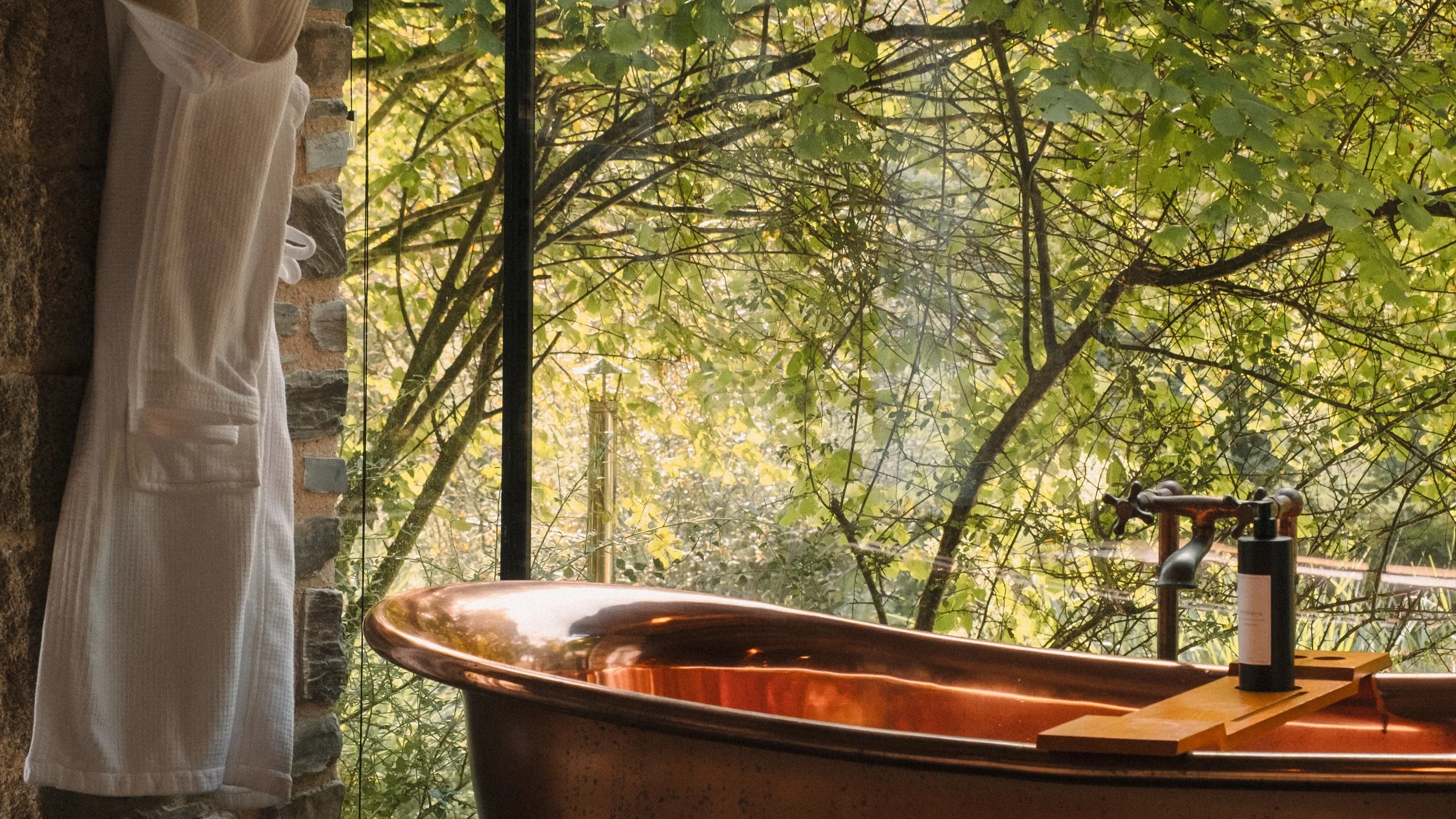 A quiet corner designed for lingering moments, where soft light, warm textures and gentle shadows set the tone for complete relaxation