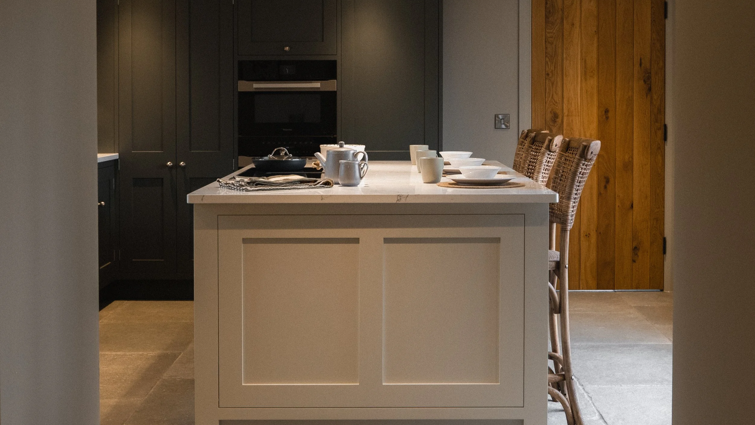 A generous, light-filled kitchen with a striking central island, where modern luxury meets farmhouse charm.