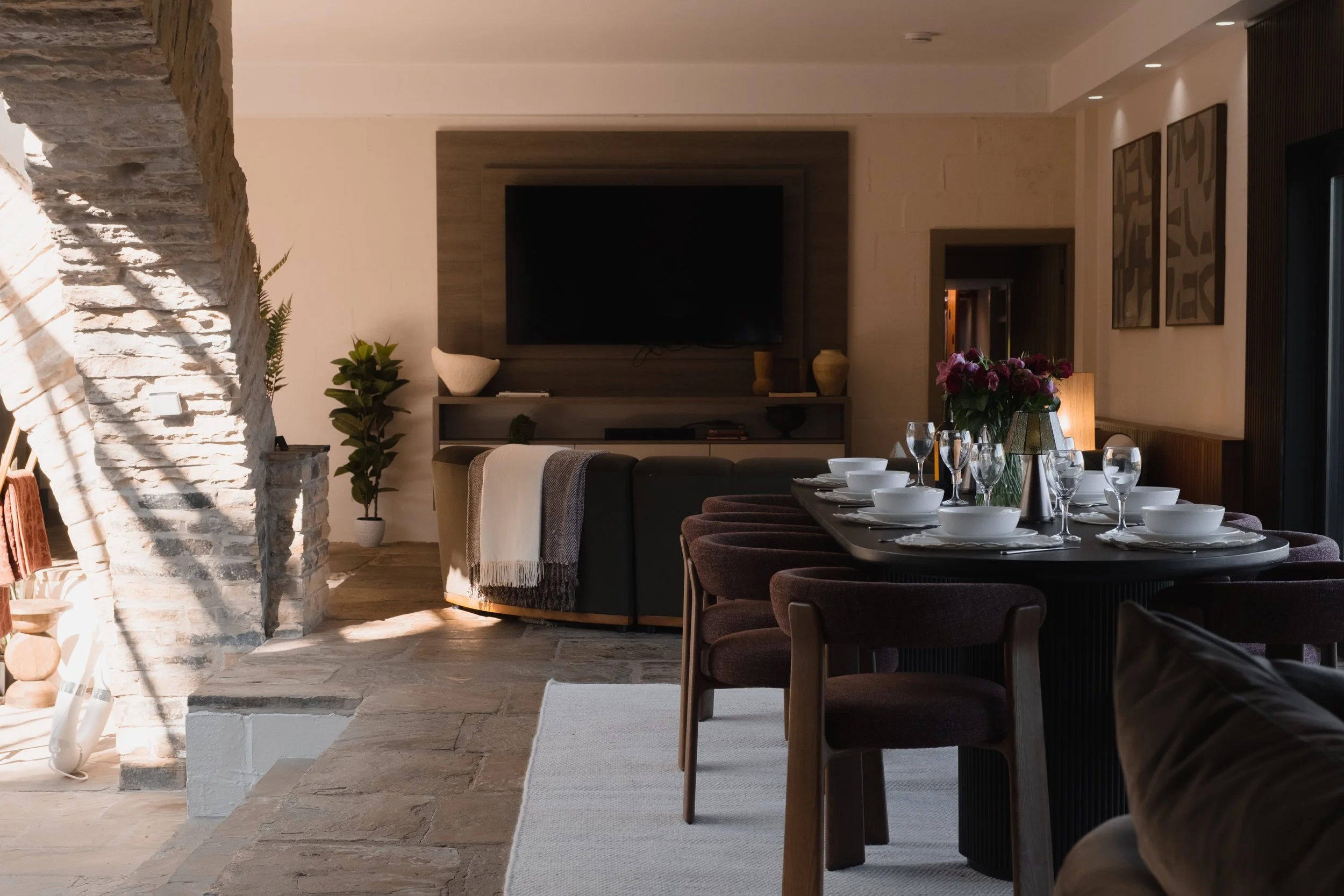 Gather around Underhill’s elegant dining table for memorable meals, surrounded by original stonework and warm, atmospheric interiors.