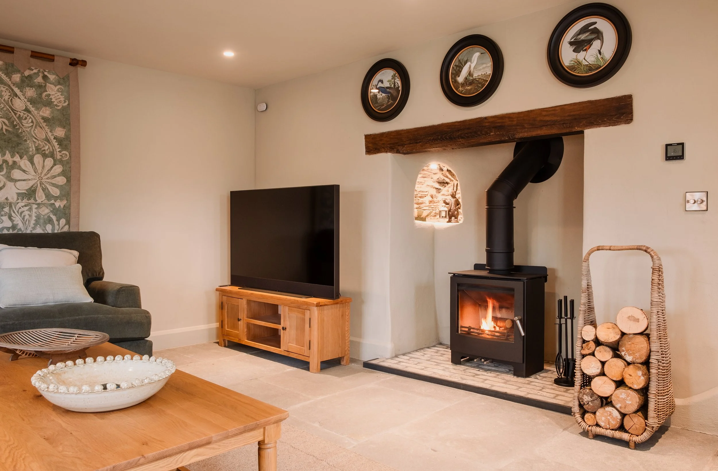 A second fireside setting invites you to sink into softness, with flickering flames, conversation and long, unhurried nights