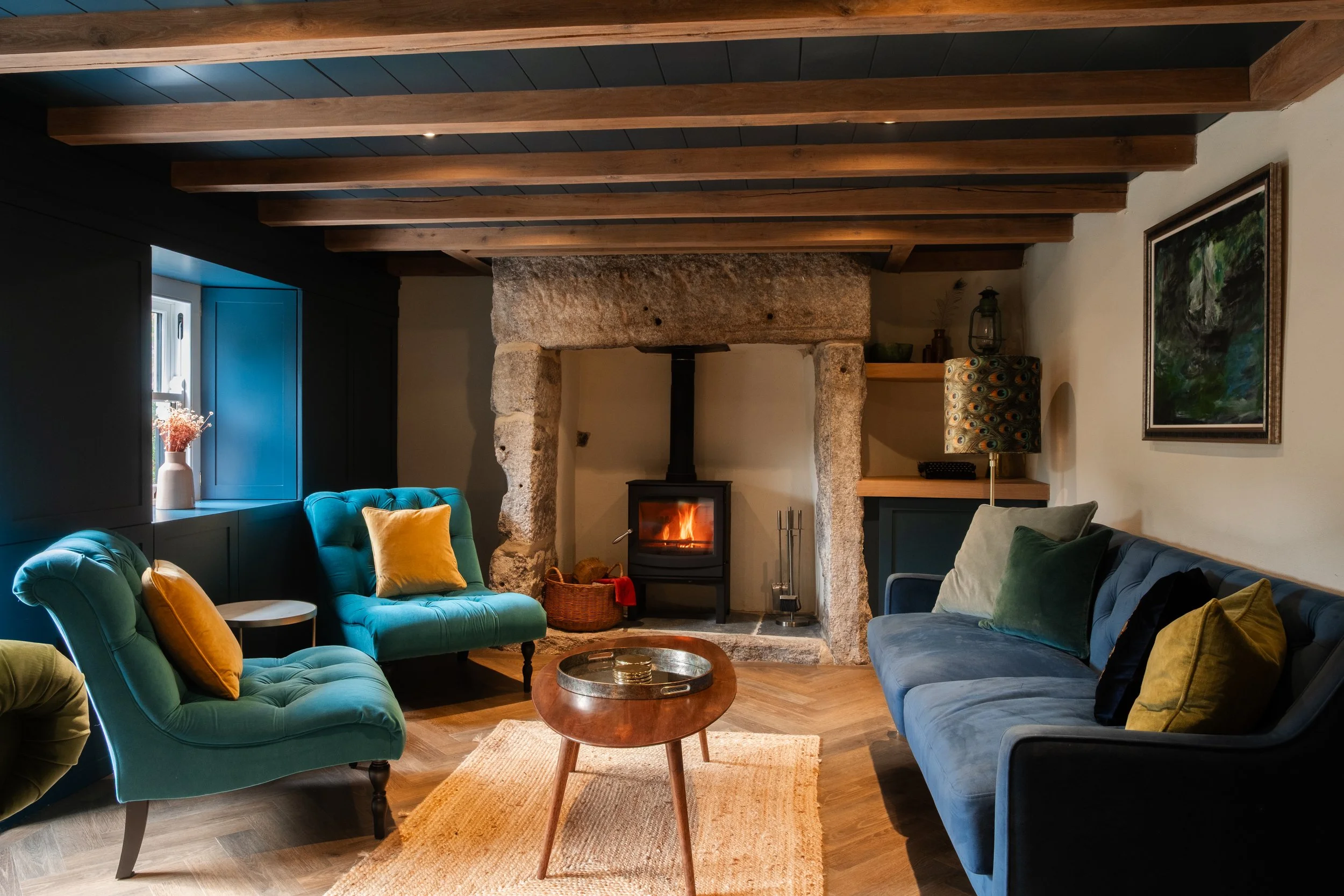With its stone fireplace, exposed beams and inviting seating, the snug is made for slow evenings and lingering conversation. As the fire glows, the room becomes a warm, intimate retreat at the heart of the home
