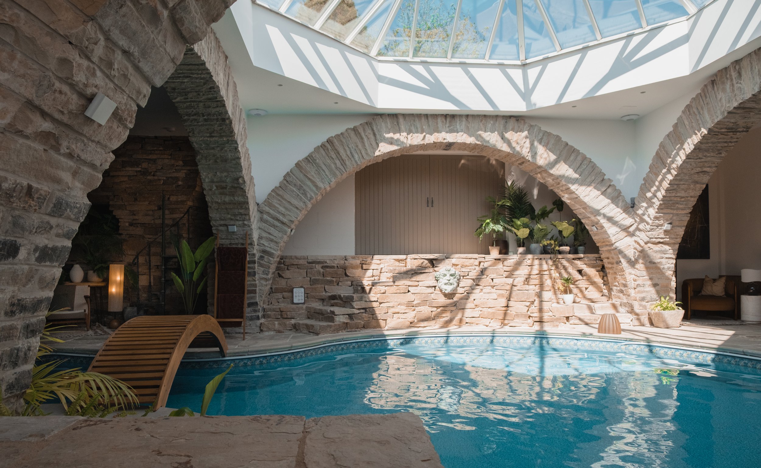 Take a dip in Underhill’s unique indoor swimming pool, framed by dramatic stone arches and illuminated by natural light from the glass skylight above.