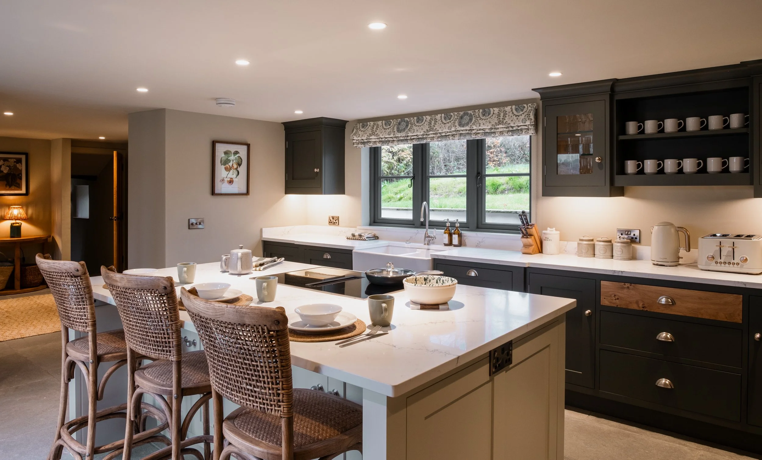 Wide windows draw the gardens in, flooding the space with natural light.