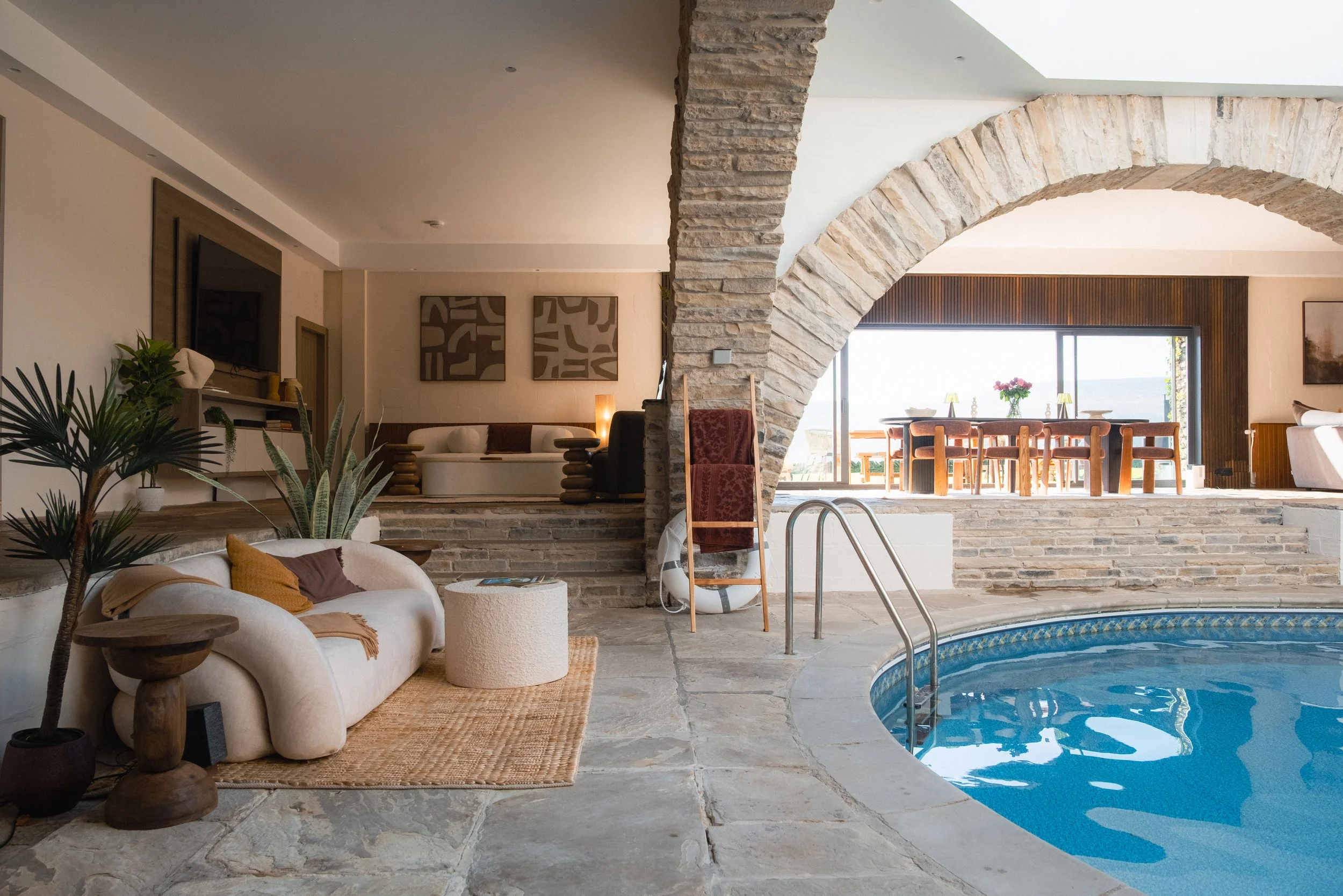 With cosy seating and dramatic stone arches leading through to the light-filled dining area.
