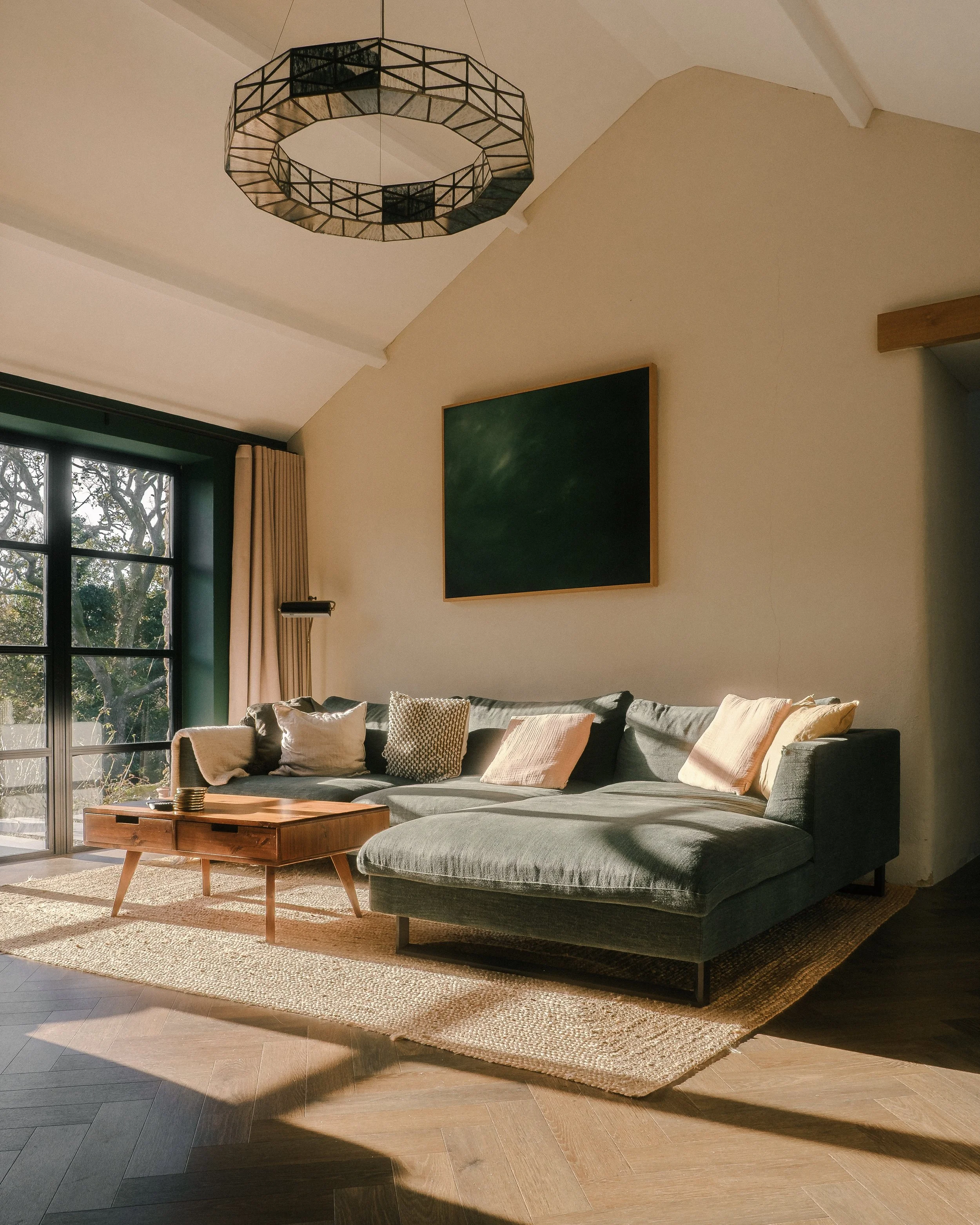 As the day fades, golden hour drifts gently through the room, casting everything in a warm, honeyed glow. It is the kind of light that invites you to pause, settle in, and stay a little longer.