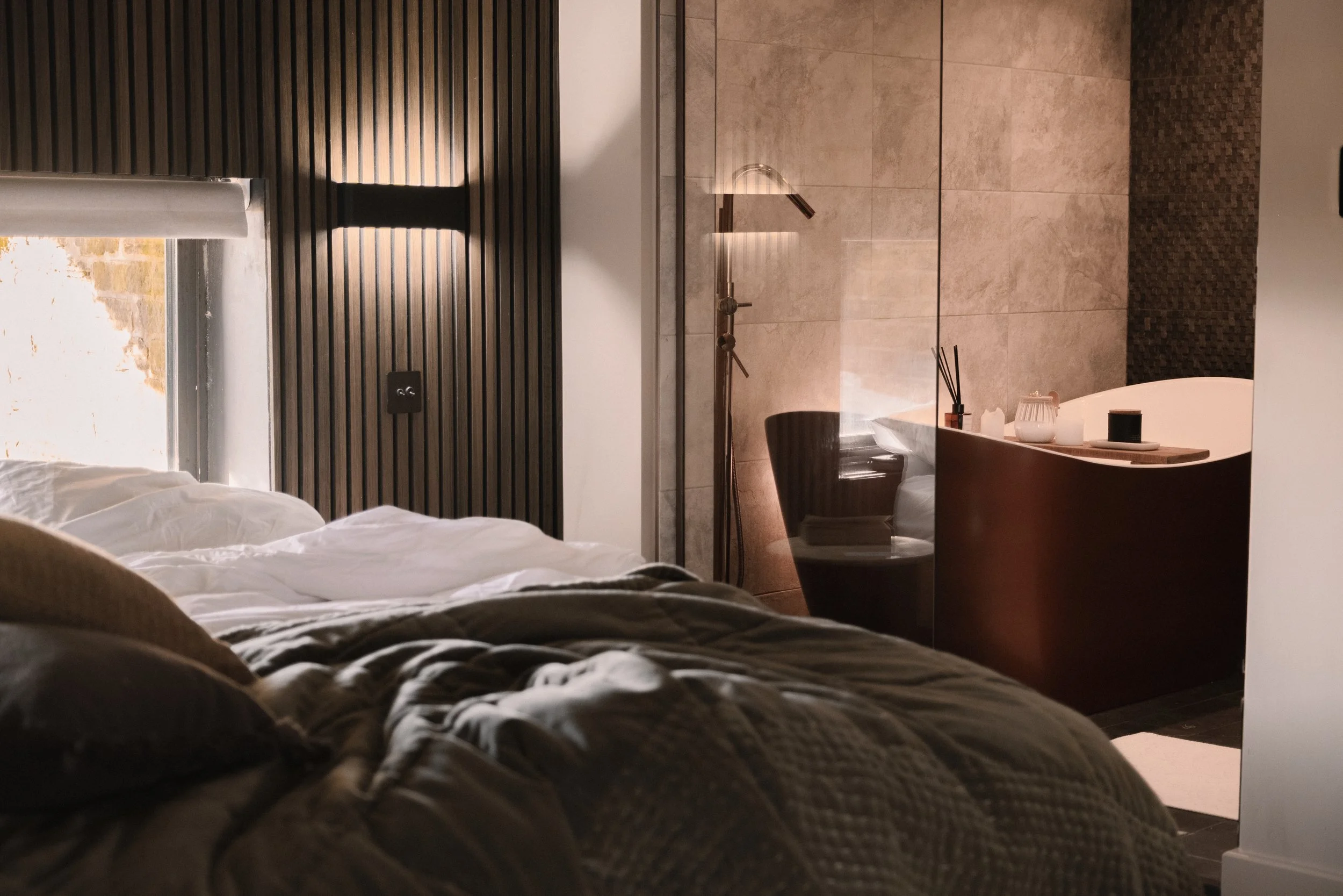 Featuring rich, restful tones and a beautifully designed open en-suite bathroom.