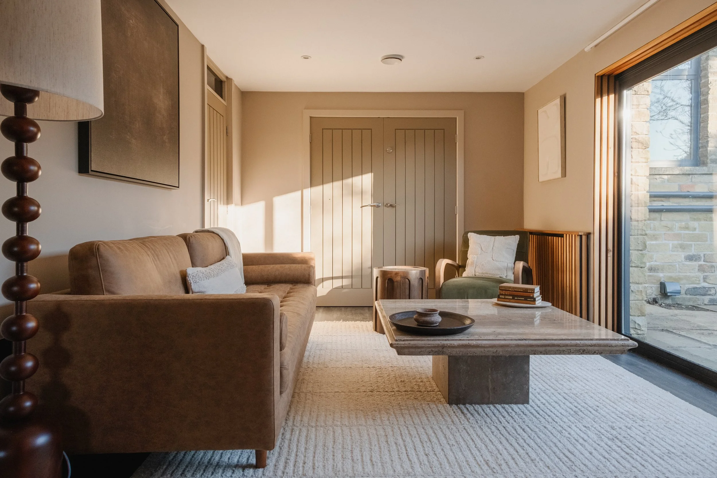 Settle into Underhill’s cosy living room, with comfortable seating, warm neutral interiors and large windows overlooking the surrounding stonework and garden.