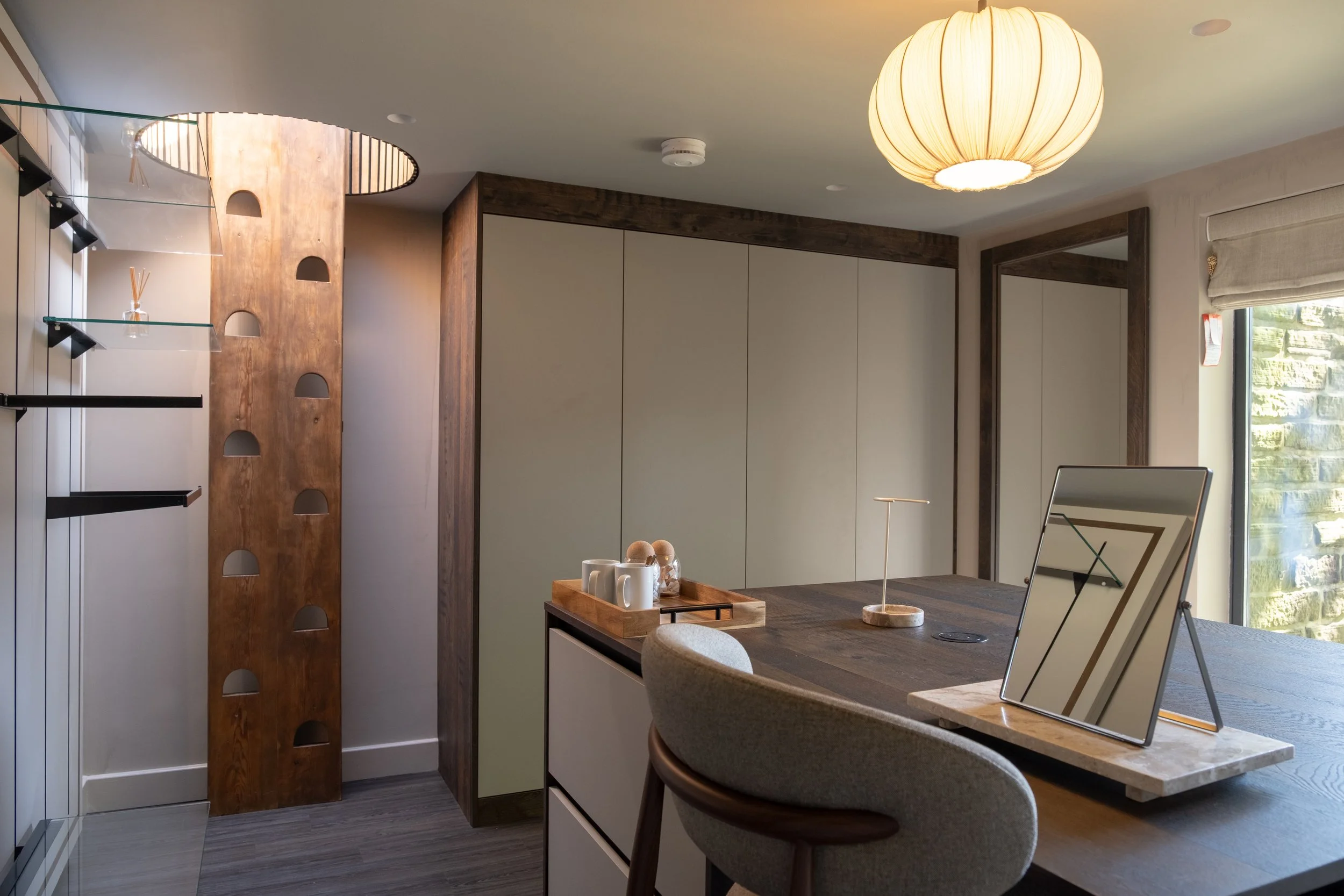 Unpack and get ready in Underhill’s beautifully designed walk-in wardrobe, with extensive fitted storage, a central dressing island and dedicated vanity area.