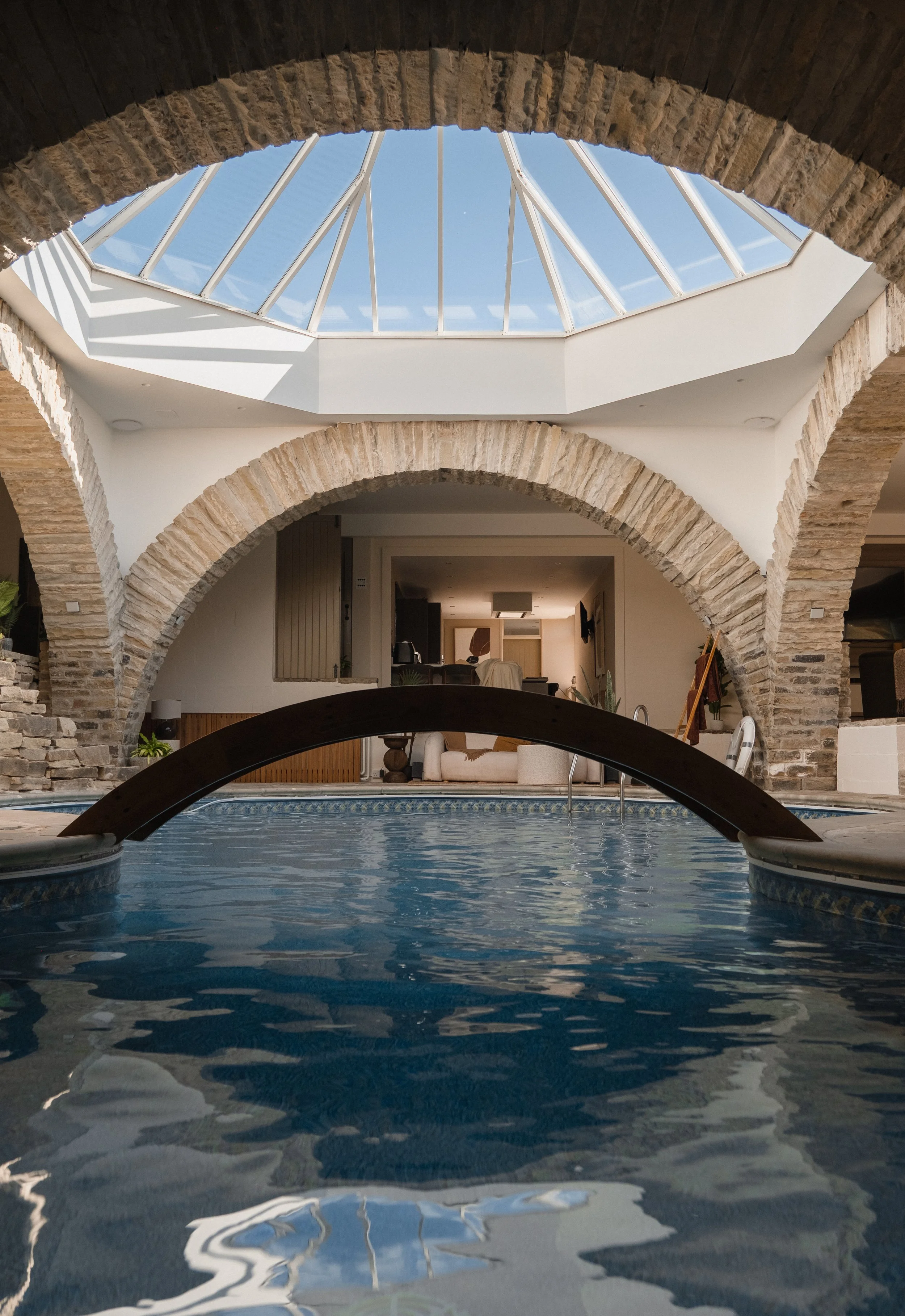 Swim beneath Underhill’s spectacular glass skylight, where a sculptural bridge and sweeping stone arches frame the atmospheric indoor pool.