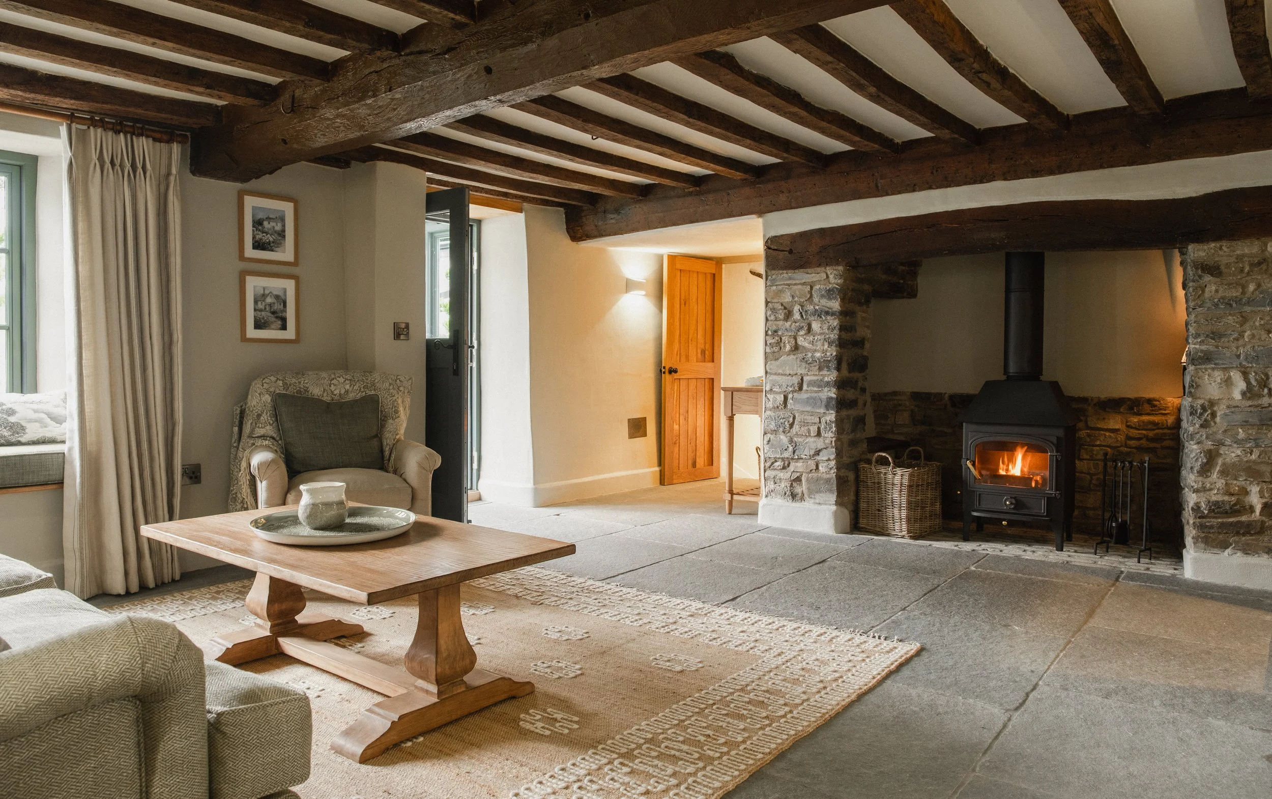 rand stone fireplace anchors the space, perfect for slow evenings, shared stories, and winter escapes.