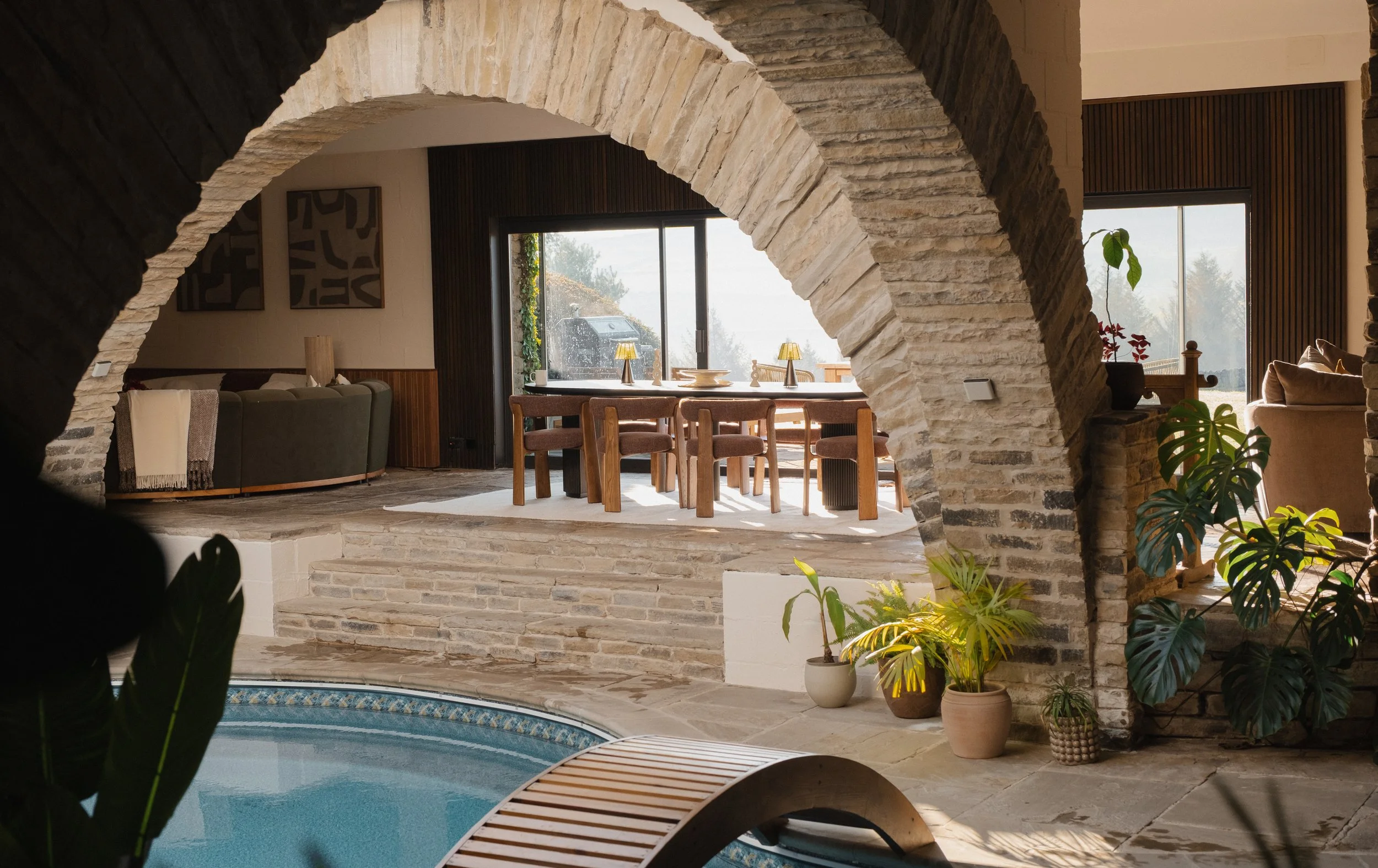 Swim beneath Underhill’s dramatic stone arches, with the private indoor pool flowing seamlessly into the home’s unique open-plan living and dining spaces.