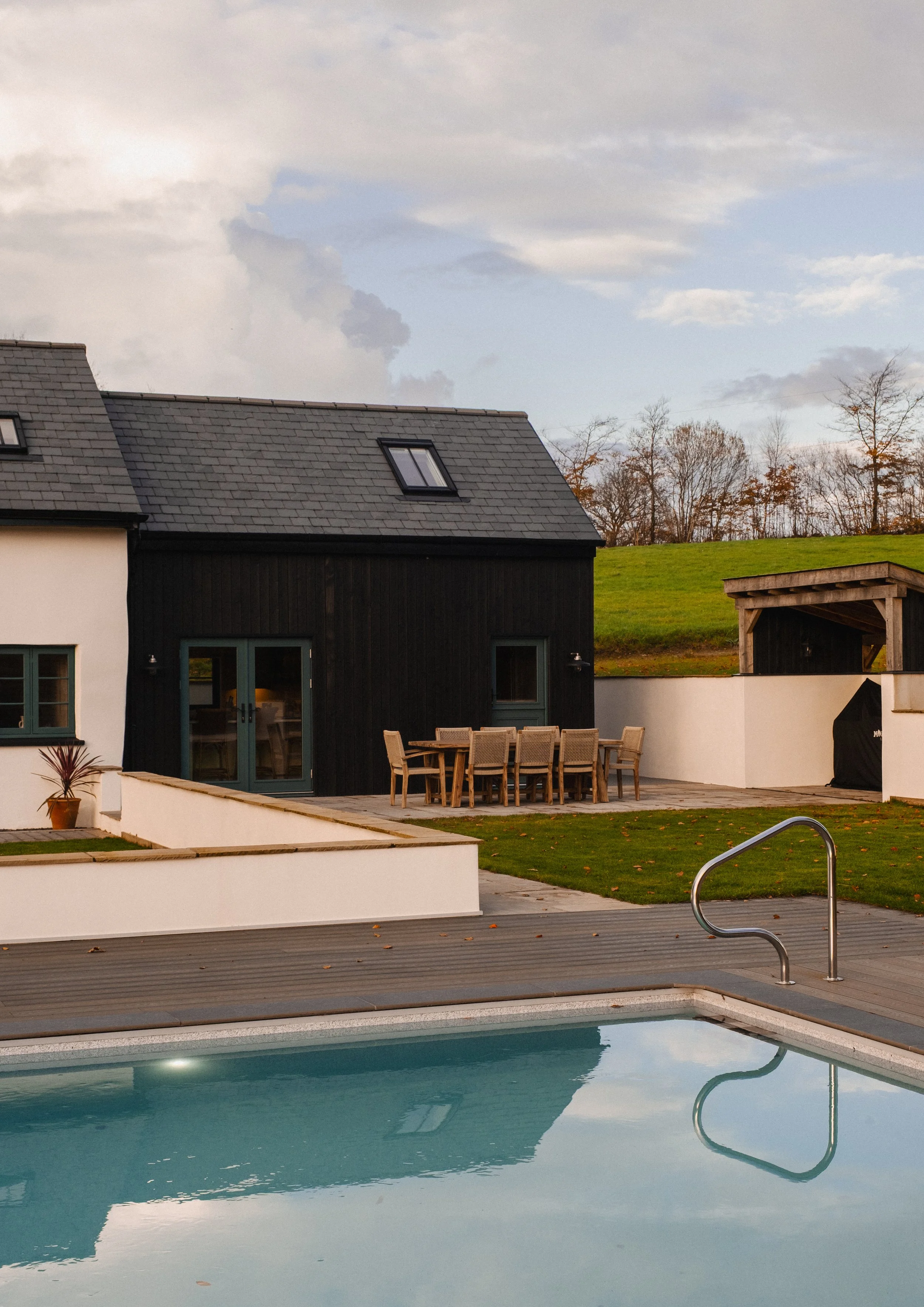 Just beyond the pool, the outdoor kitchen and dining terrace invite long, sun-soaked lunches and golden-hour feasts, fully equipped with a built-in BBQ, sink, fridge and generous seating.