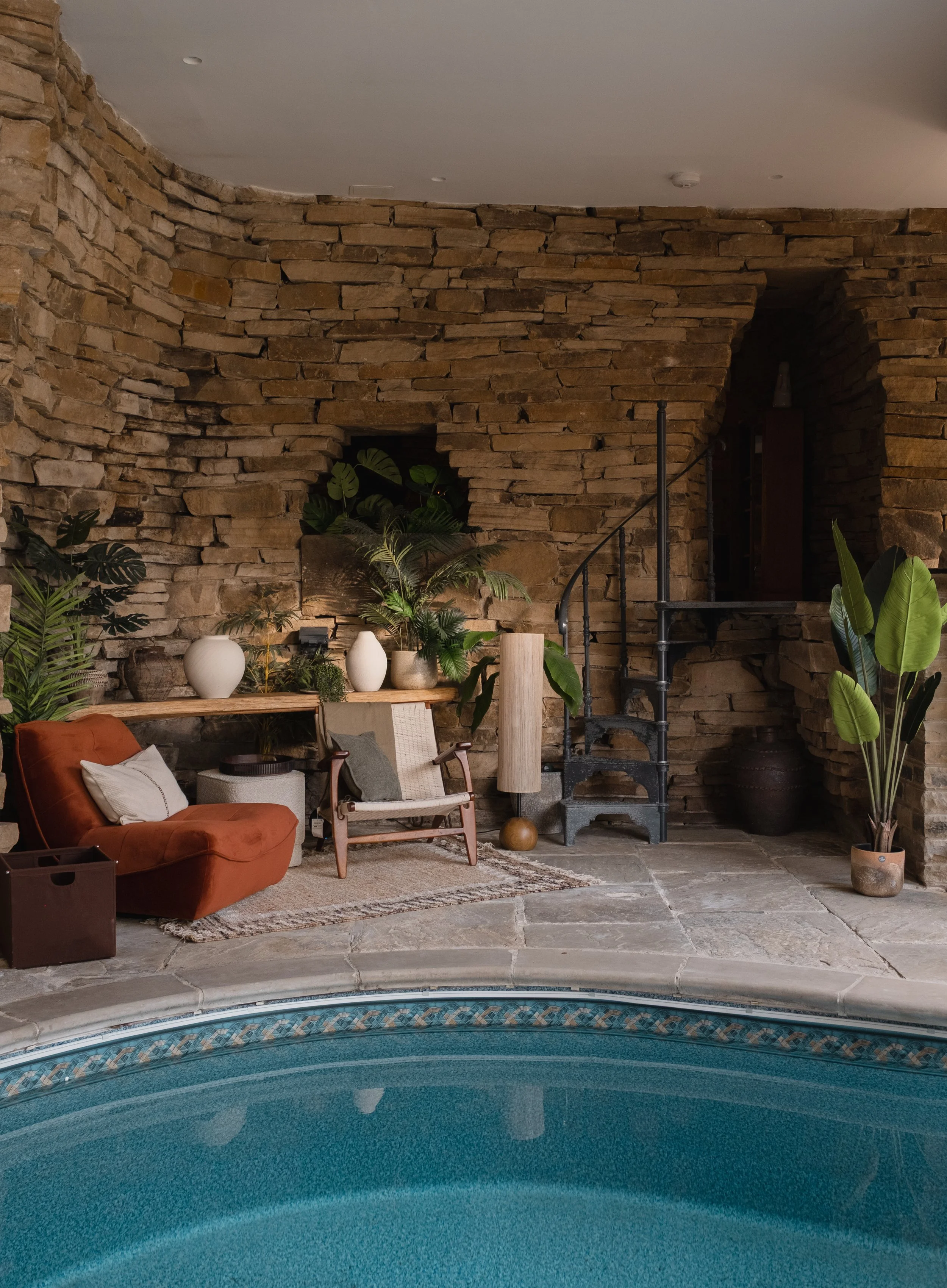 Settle into Underhill’s cosy poolside seating area, surrounded by characterful stone walls, vibrant greenery and warm, inviting furnishings
