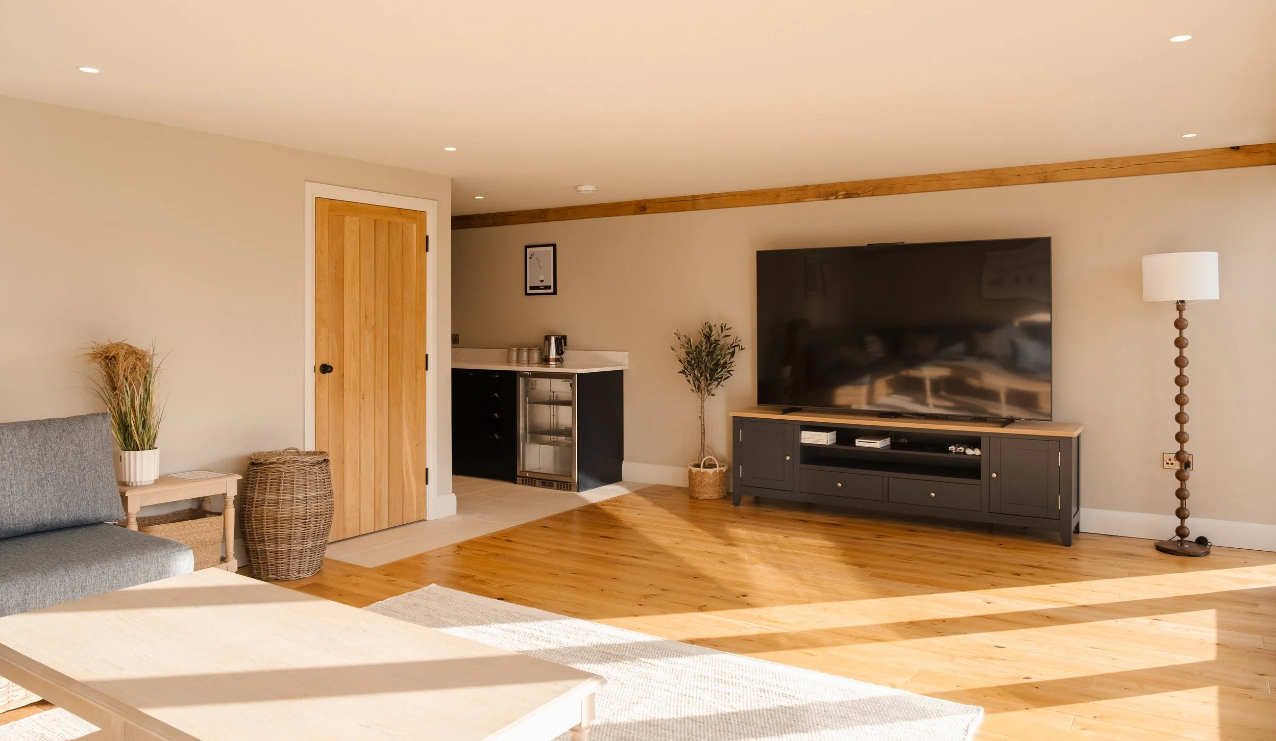 an impressive 85-inch television anchors the entertainment space, paired with a sleek kitchenette and lavatory,  designed for effortless hosting, relaxed movie nights, and seamless days spent by the pool.