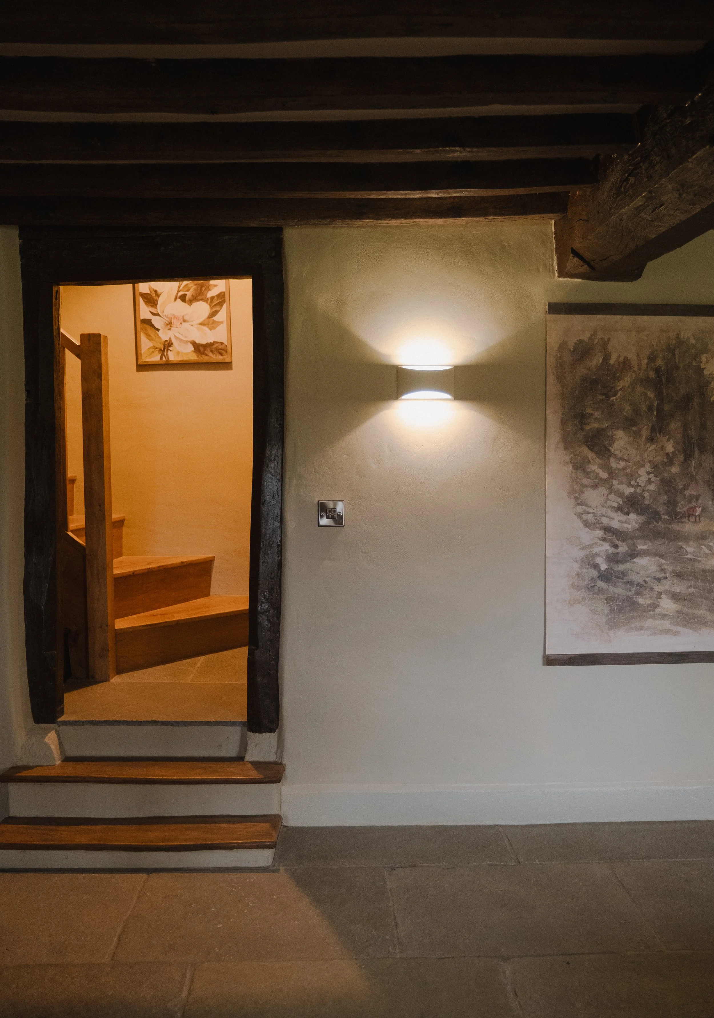 A seamless blend of old-world charm and modern comfort as you approach the staircase.