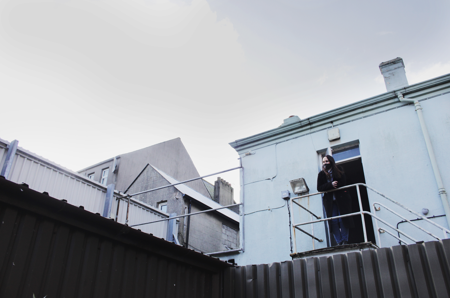 Sarah standing above the courtyard at what is now the upstairs kitchen window