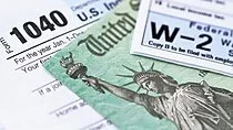 Close-up of a U.S. federal income tax form with a partial illustration of Lady Liberty holding a torch.