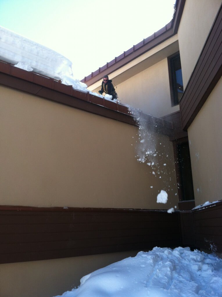 Clearing snow off the Purgatory Village Center Building