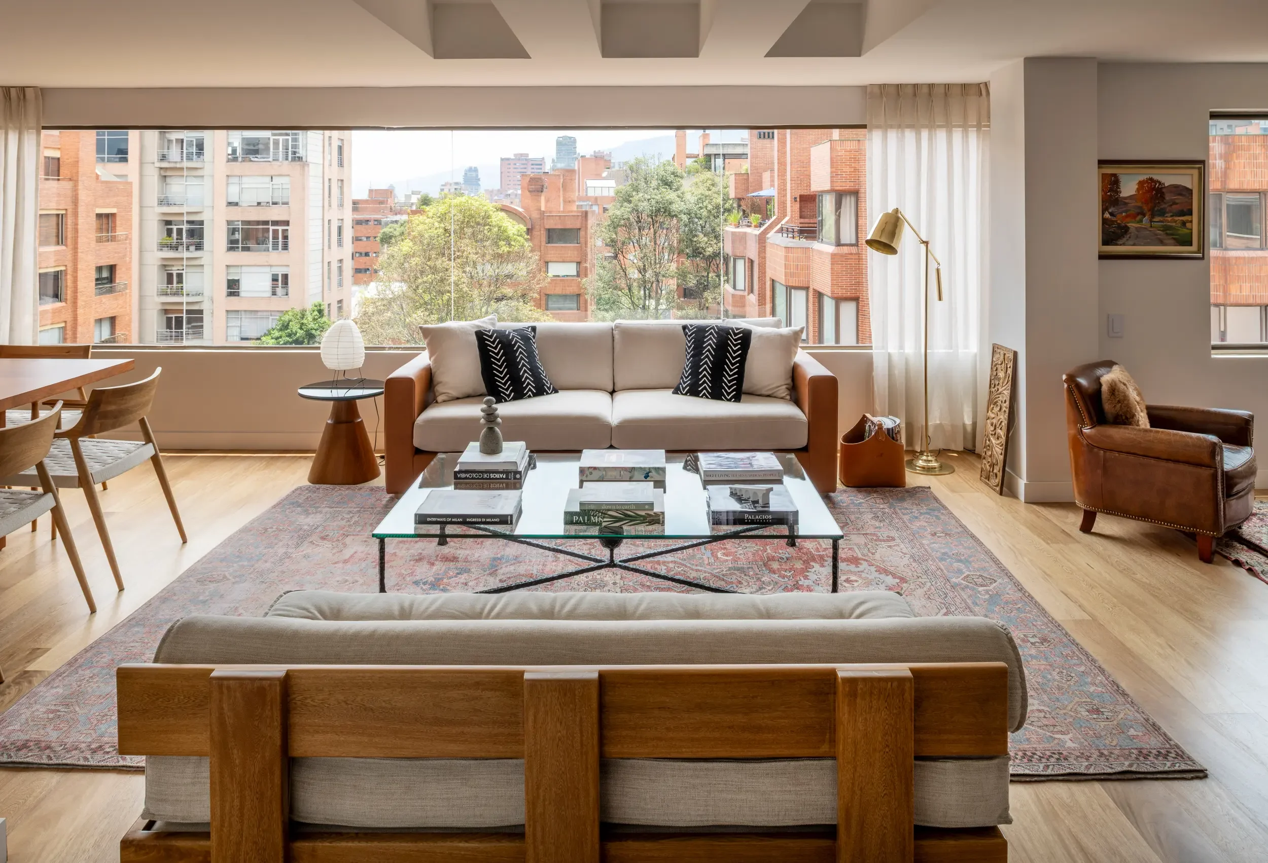 Natural light flooding the interior of a renovated Bogotá apartment, brightening the living area