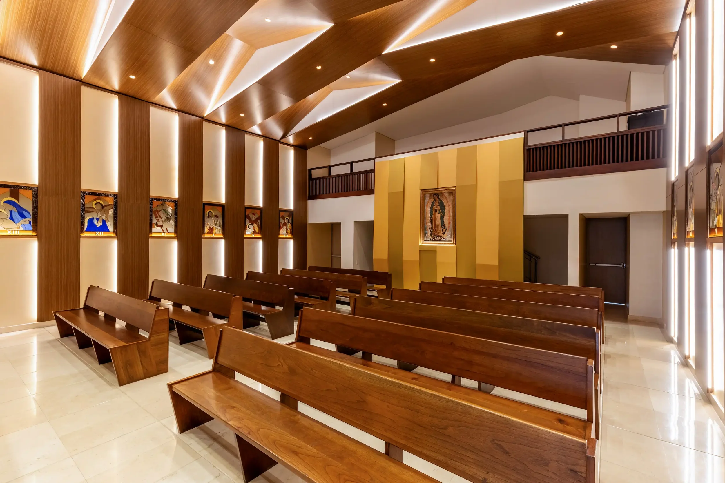 Carefully considered lighting in the Mantle Chapel, Bogotá, casting a gentle balance of light and shadow across the worship space Image 4 Alt: The Mantle Chapel interior at full capacity, demonstratin
