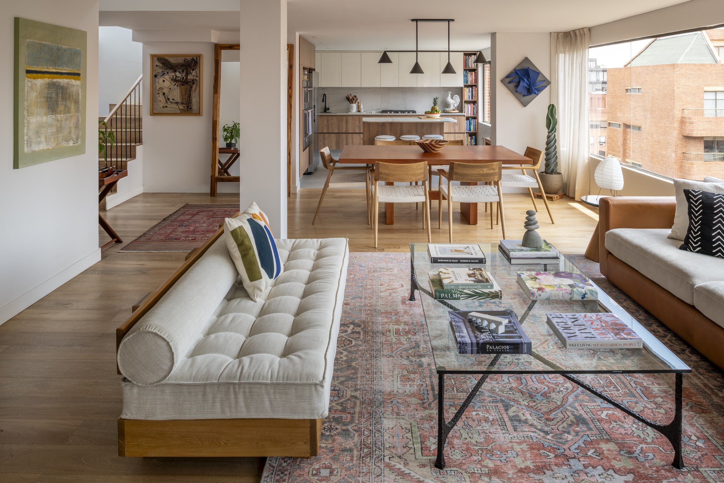 ransformed Bogotá apartment with a unified open layout and floor-to-ceiling openings, offering stunning exterior views and redefining compact living