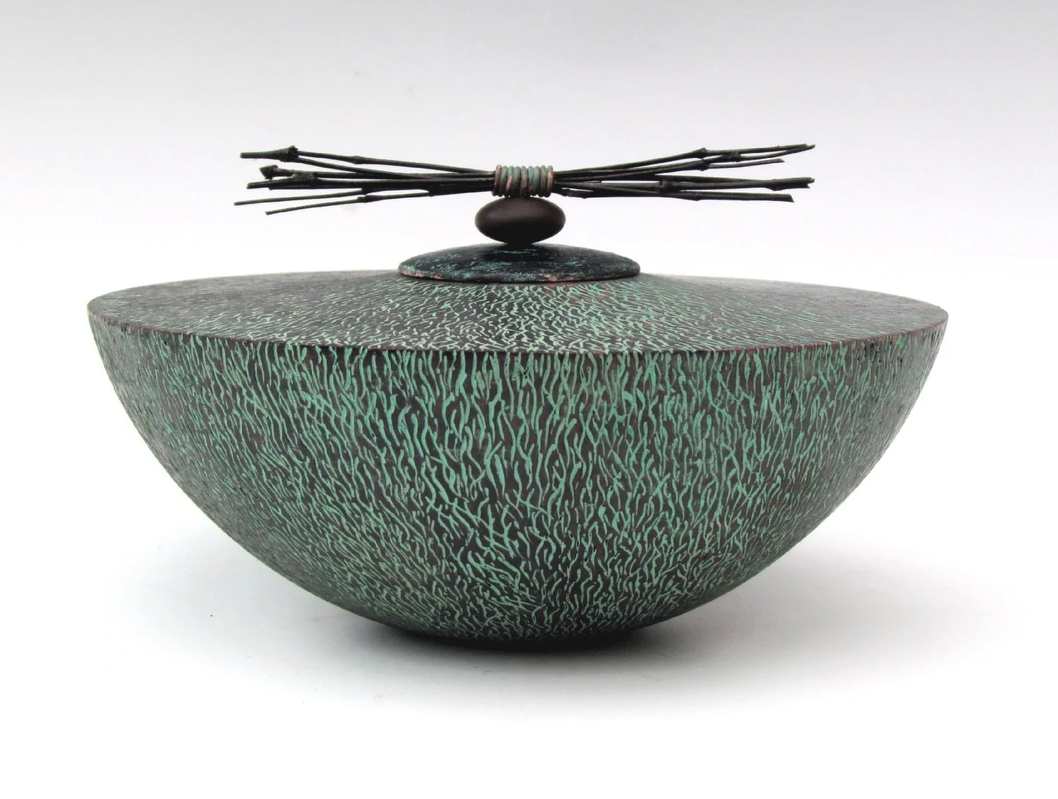 Hollow lidded form with a textured surface, inspired by the philosophy of impermenance.