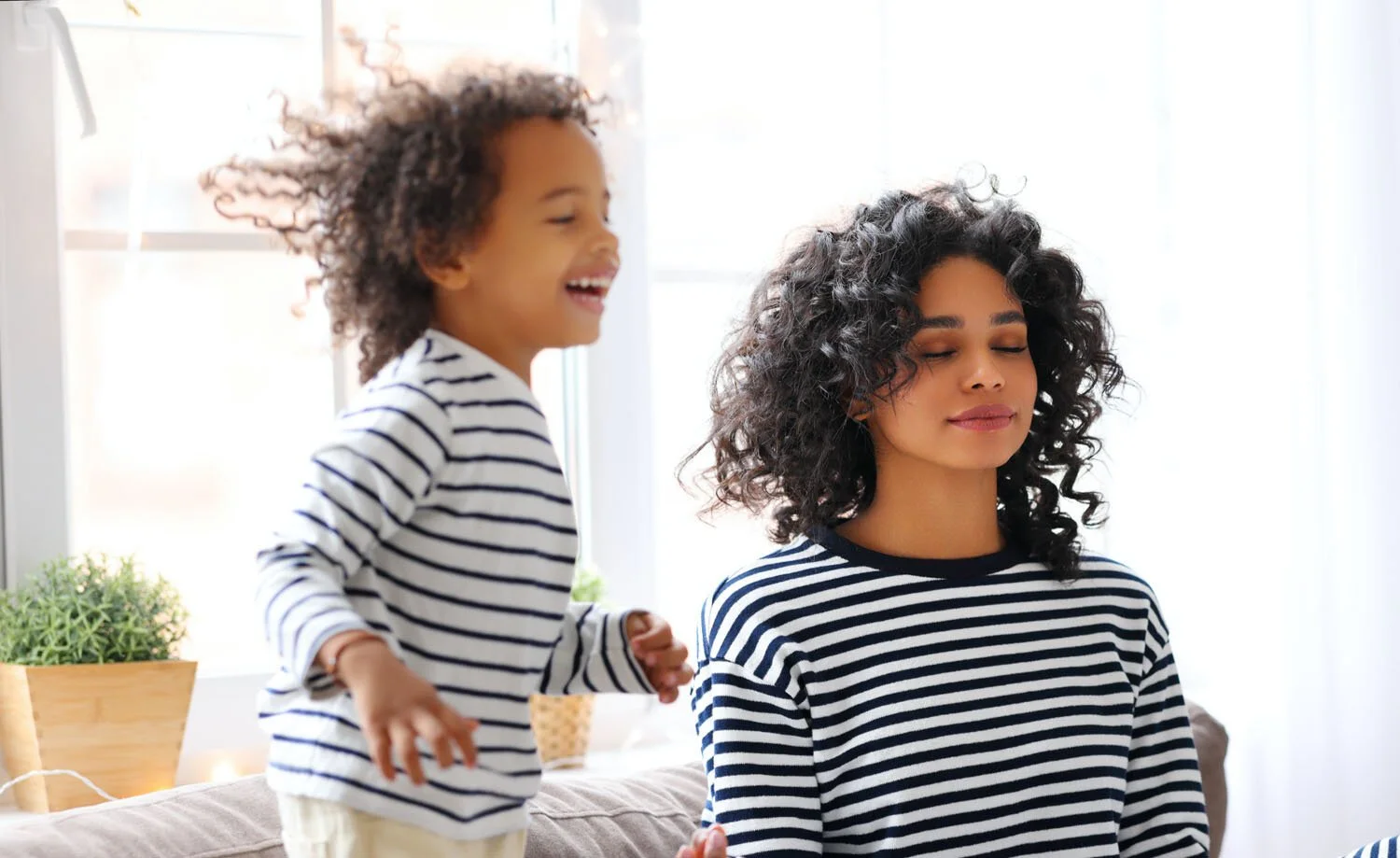 Woman doing Vedic Meditation with jumping toddler and able to focus