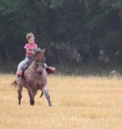 Lexi racing across the field