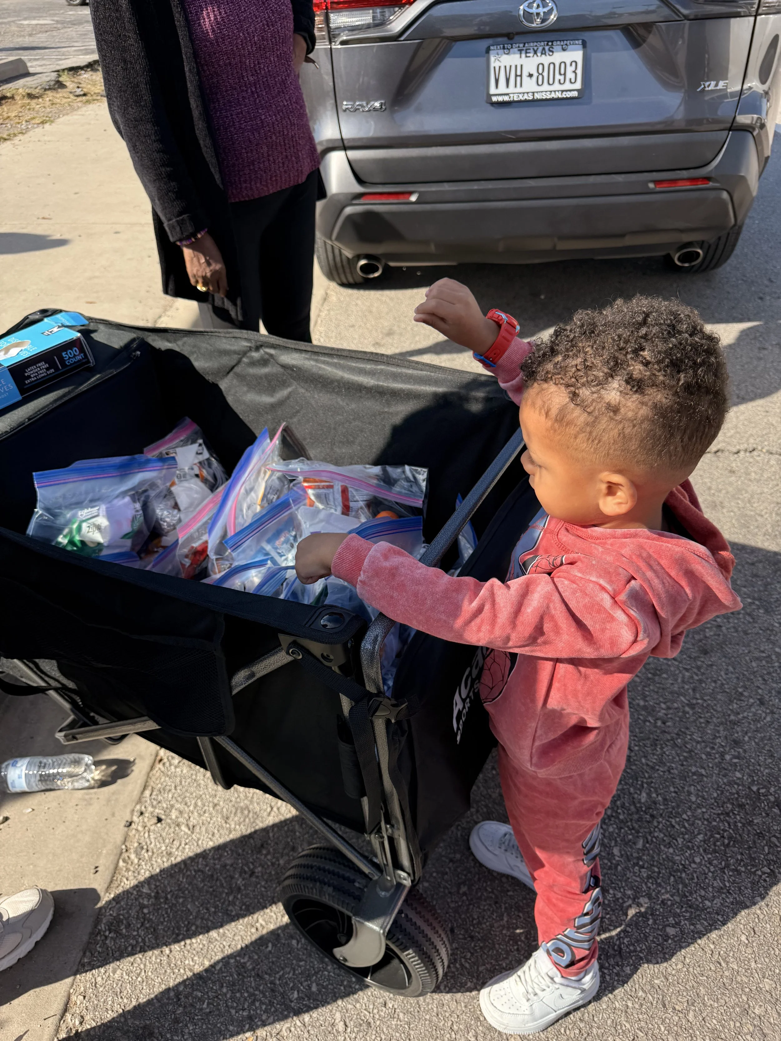 Little child picking up food. 