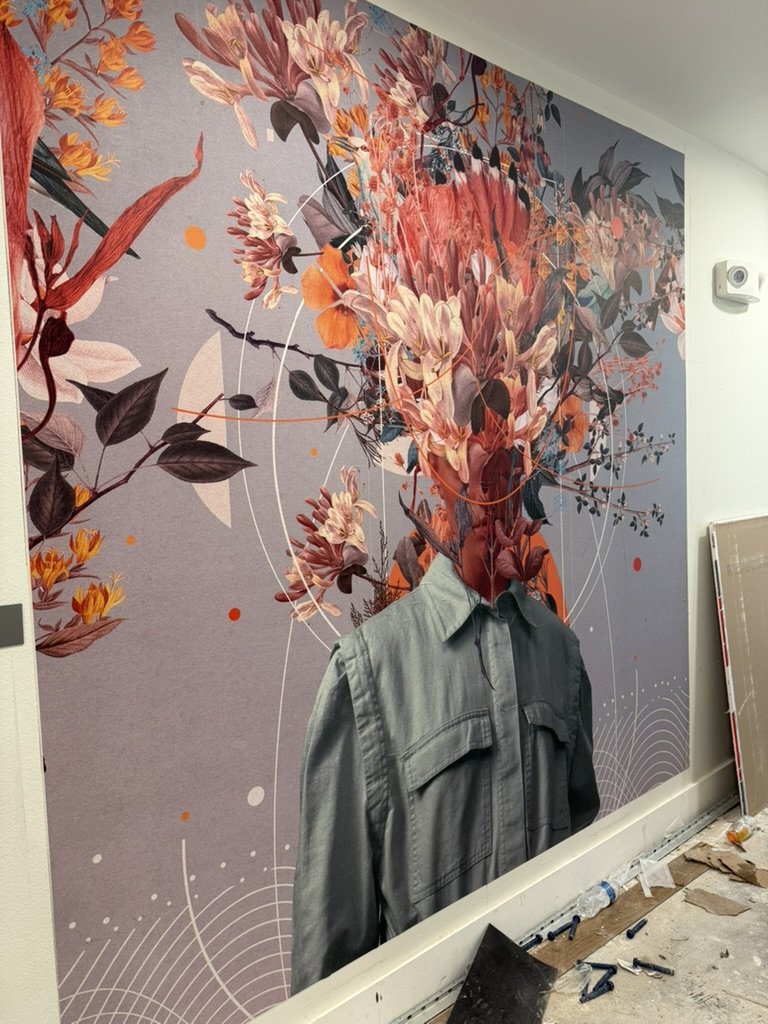 Custom Frank Moth surrealist floral wall mural installation in a resident corridor at East 9th in Dallas, TX, designed by Artbuckle & Co.