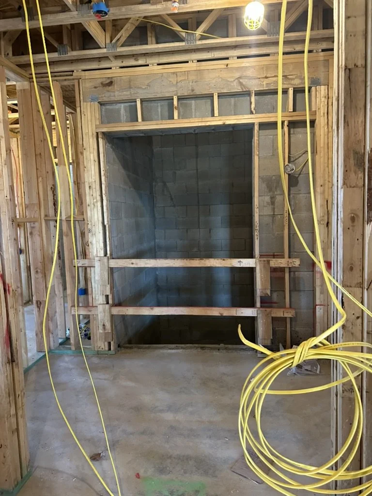 Interior wall framing and electrical rough-in at the elevator lobby for Beacon apartments in Frisco, TX, managed by Artbuckle & Co.