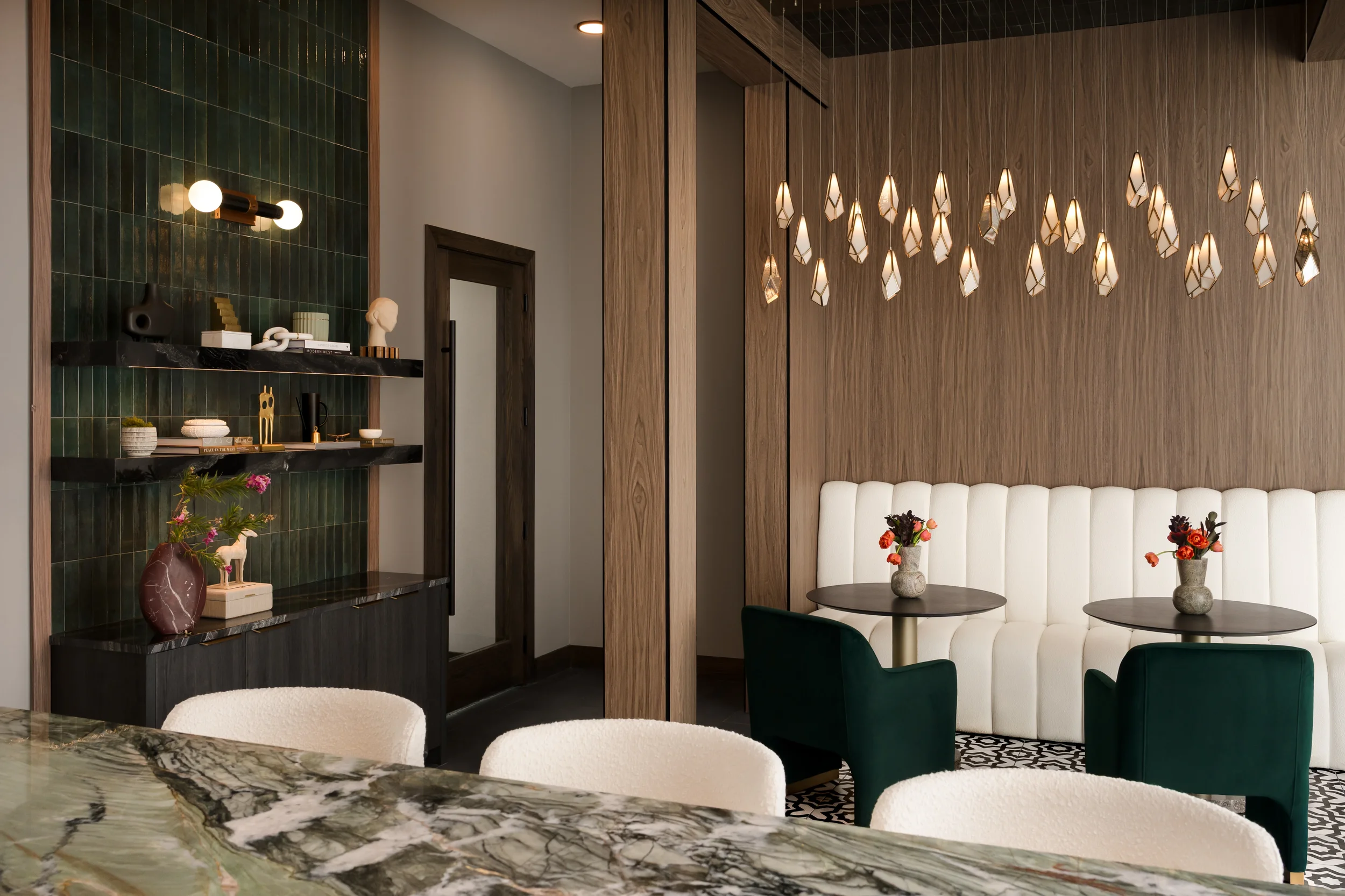 Café nook with banquette, marble table and walnut columns at The Platform in Frisco, TX. Designed by Artbuckle & Co.