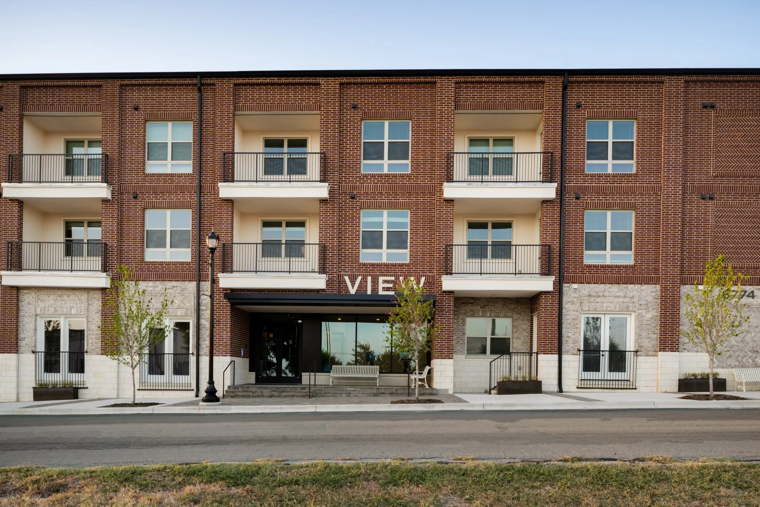 Brick exterior and entrance of The View apartments in Frisco's Rail District.