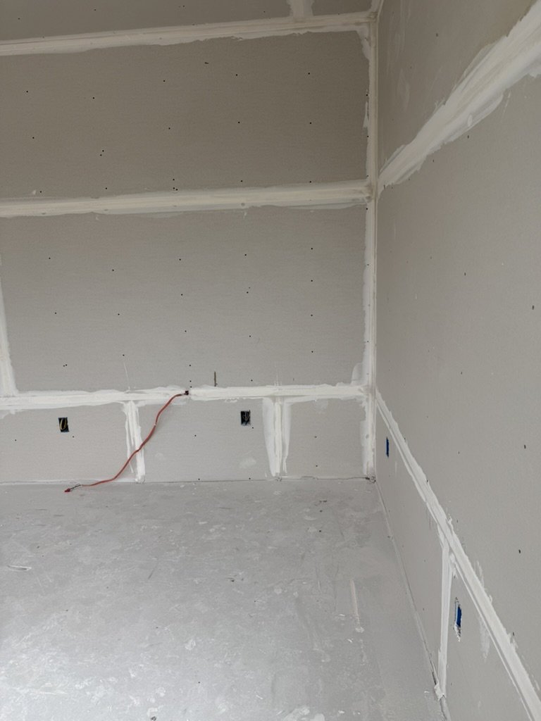 Raw drywall framing and electrical wiring phase for resident corridor and common area at Gateway Park in Dallas, Texas, by Artbuckle & Co.