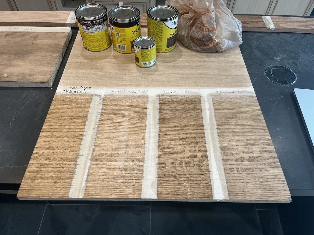 Wood stain samples on oak for The View in Frisco's Rail District, labeled with walnut and aged stain options. Designed by Artbuckle & Co.