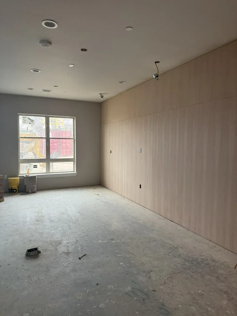 Oak-paneled amenity room under construction at The View in Frisco's Rail District.